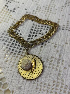 Gold tone bracelet with medallion